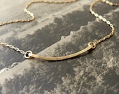 the archer - gold bar necklace - simple gold jewelry by windowsill