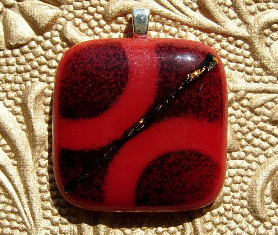 Red fused glass pendant with black frit circles