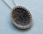 Scalloped framed pendant etched with leaves pattern