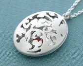 Victorian leaves open locket with faceted ruby