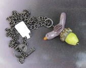 on an acorn,  purple bird and green acorn LORiOLA lampwork glass necklace