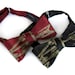 Burgundy Arrows bow tie, freestyle. Silkscreened necktie, antique brass print. "Quiver."