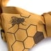 Oh Honey. Mustard yellow bow tie, self-tie. Silkscreened honeybees. Chocolate brown print.