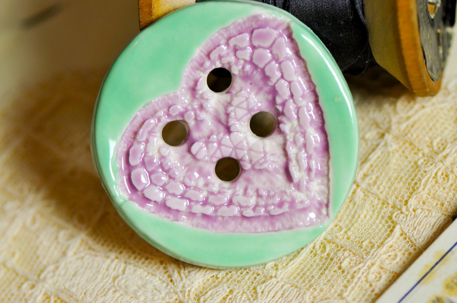 Heart button pink and turquoise.....she is a sew on button