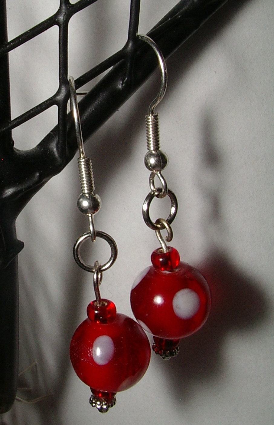red and white glass beads with silver accents dangle earrings