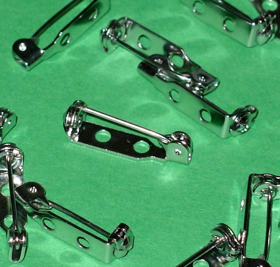 64 silver pinbacks 3\/4 inch size