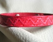 Faded red flourishes cuff