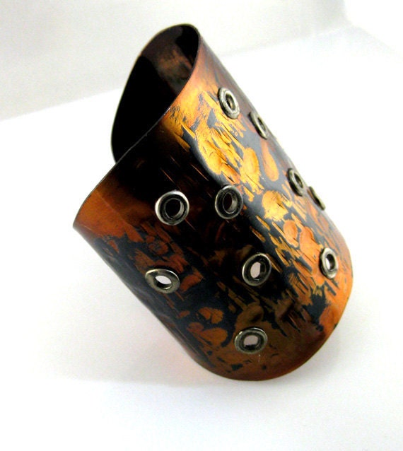 Very wide  shiny cuff. Modern, stylish,  unique finish  with hippie holes . Copper by  Fashion Brand Faina.