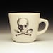 skull and cross utensils teacup