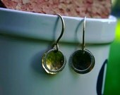 small gold disc with open braided circle earring.