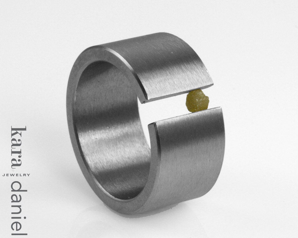 raw diamond asymmetrically tension set in stainless steel . ring