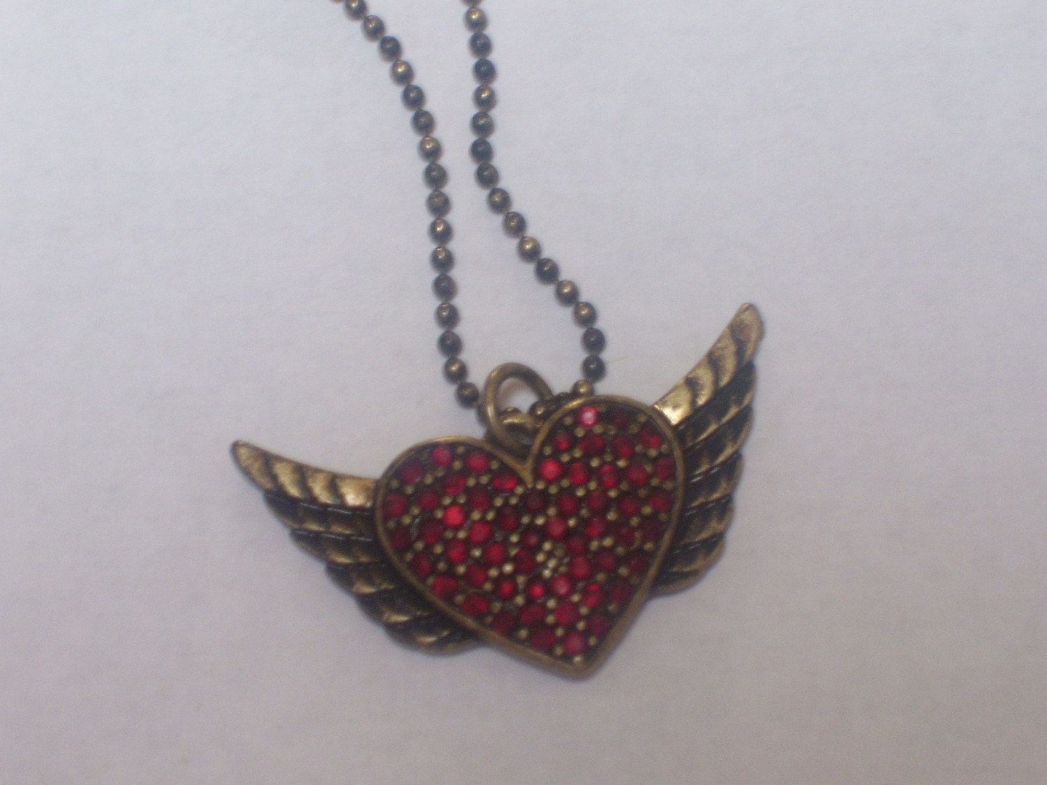 Ruby stone heart and wings necklace