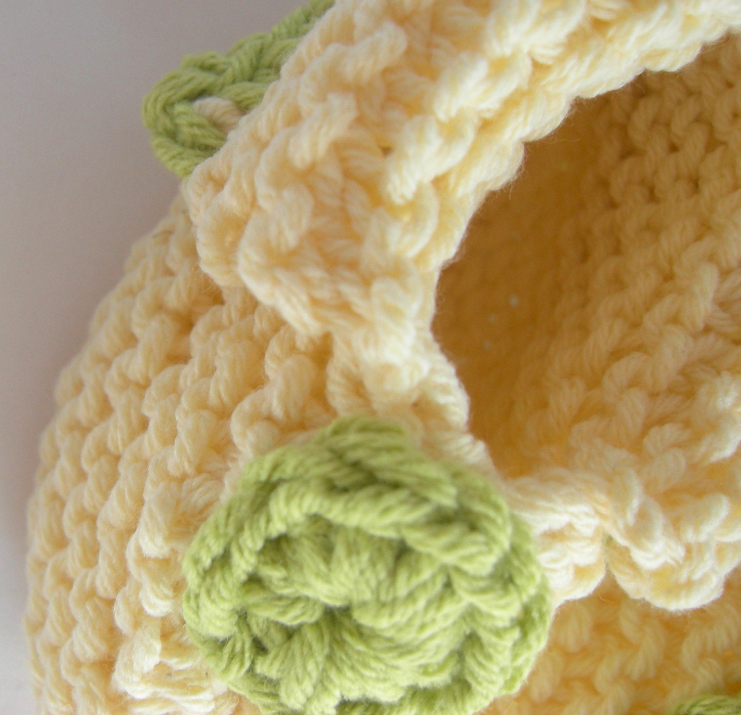 sweet cream and bright apple green baby booties