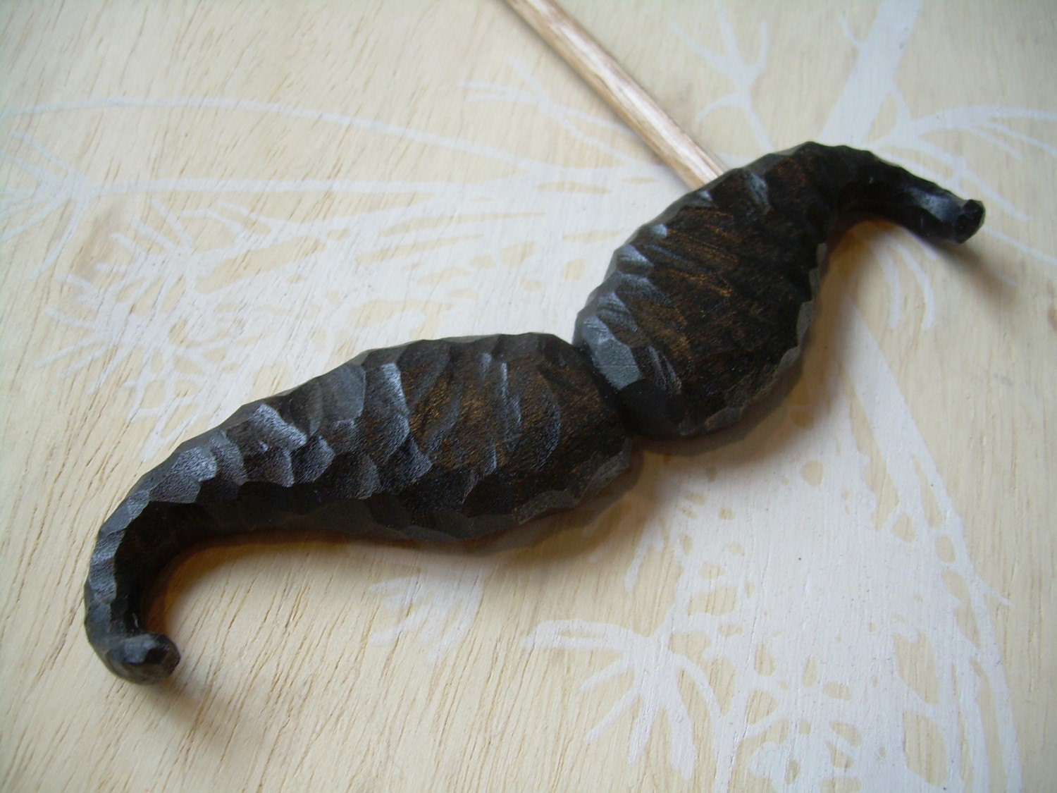 mustache on a stick
