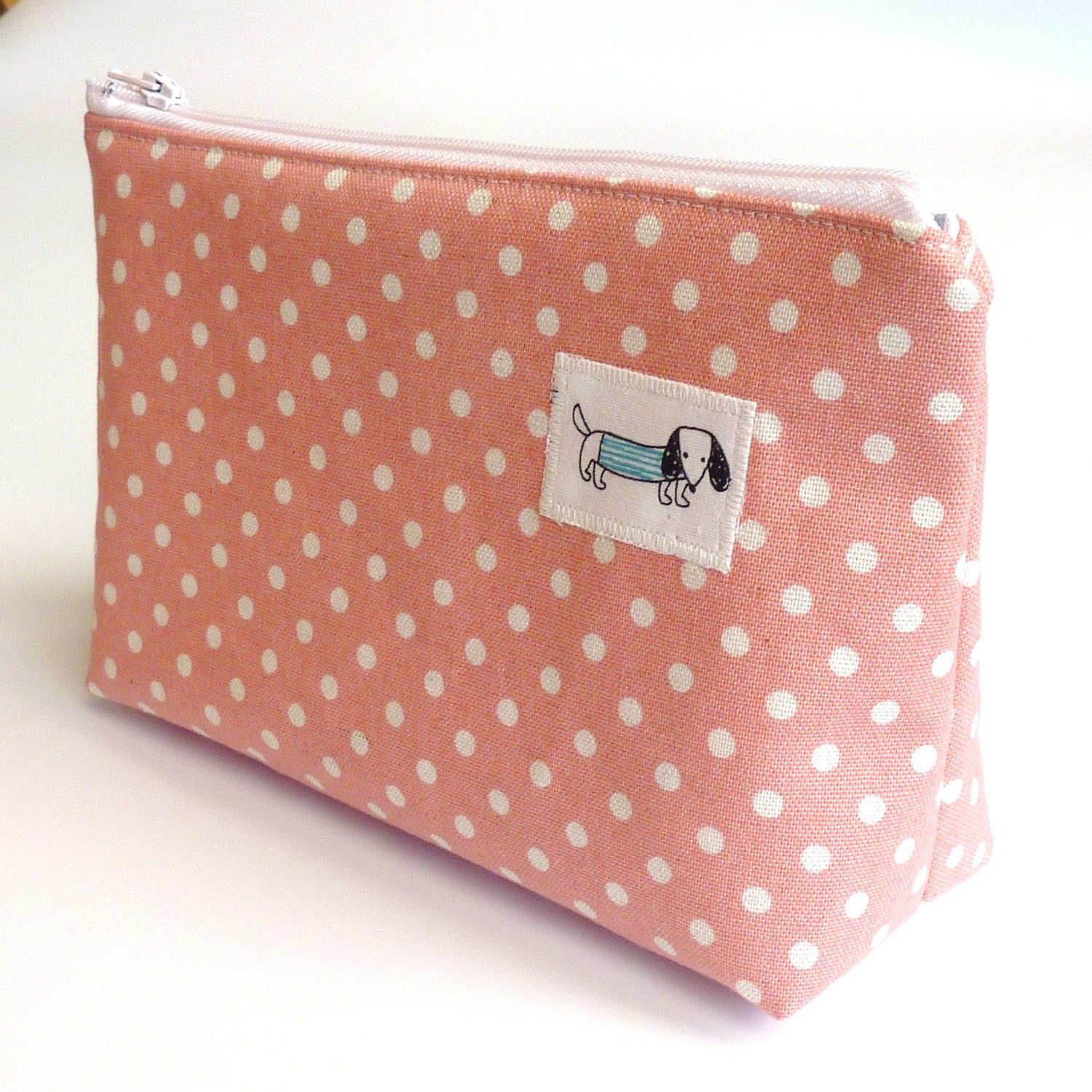 Pink polka dot zipped pouch with sausage dog motif