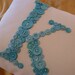 White Letter 'K' Pillow Monogrammed in Ocean Blue Buttons -- by Letter Perfect Designs on Etsy -- Any Letter Available