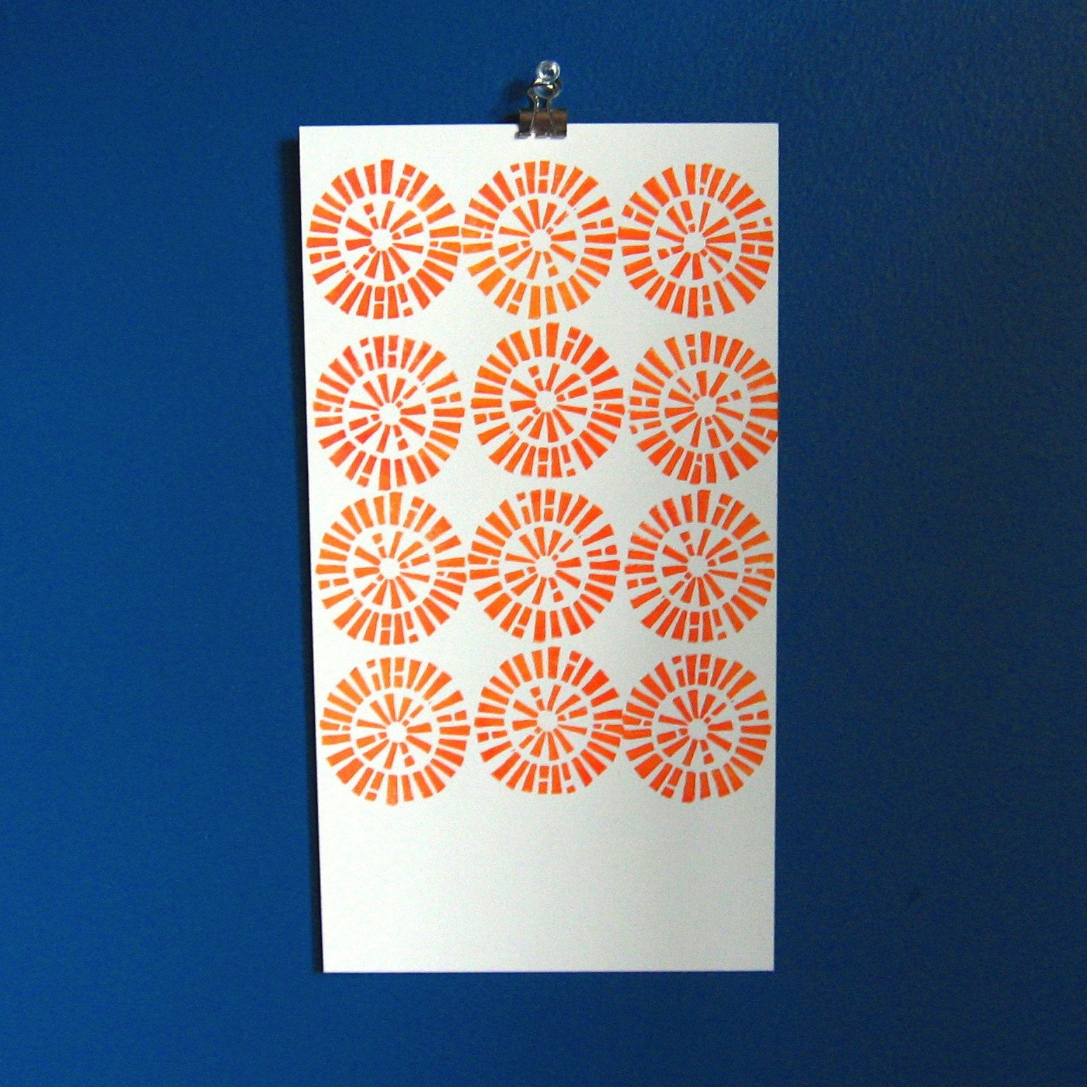 Block printed sunbursts on bristol.