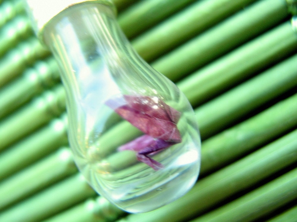 Tiny pink and green origami crane in a glass vial pendant