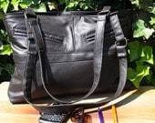 Brown leather bag with zipper closure. Recycled leather.
