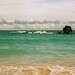 Horseshoe Bay: a fine art photograph of Bermuda seascape with sand, turquoise ocean water, cloudy sky, and large rock