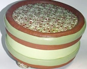 round polymer covered box in green and brown