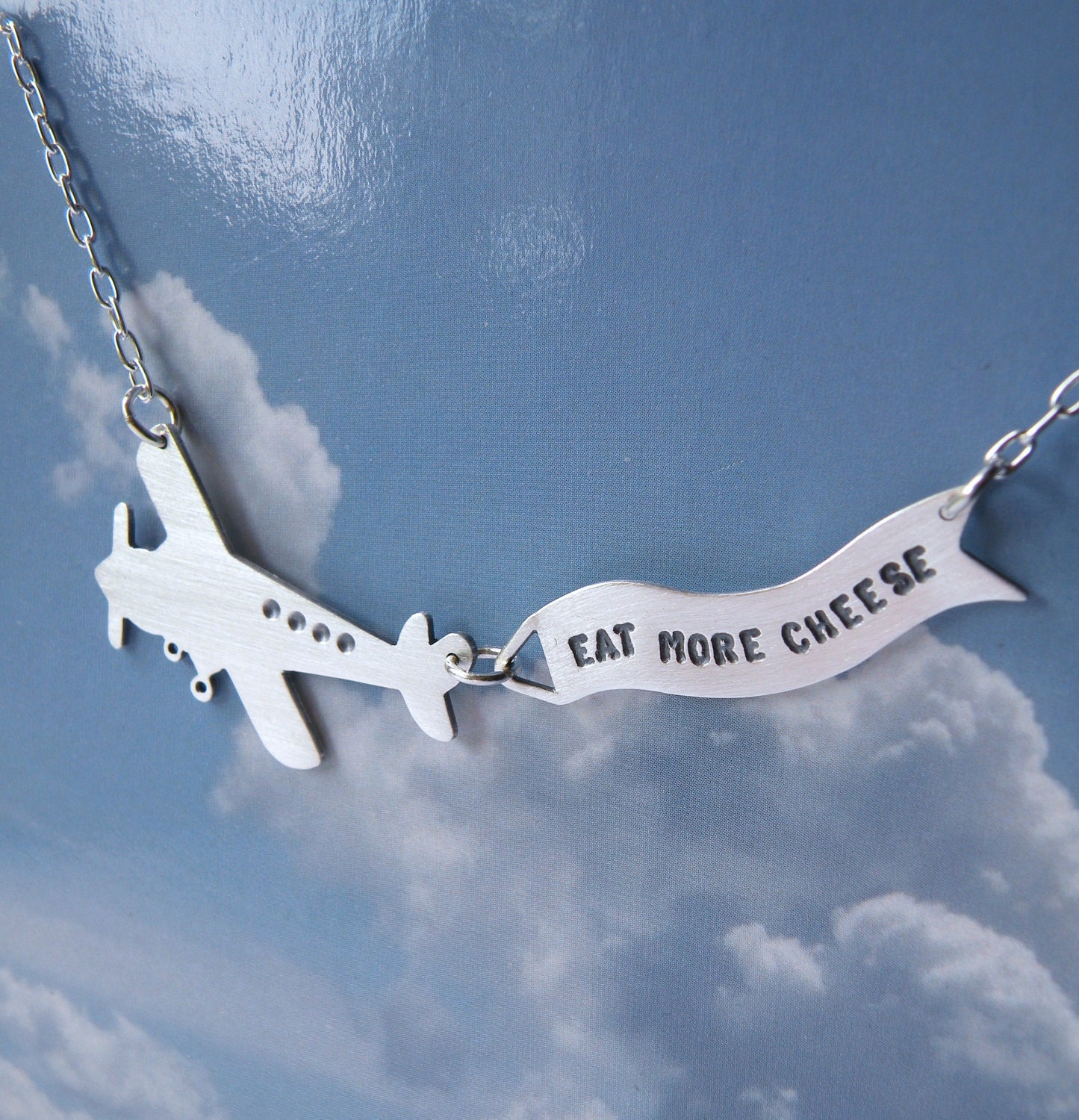 Message in the Sky - silver airplane statement necklace with banner