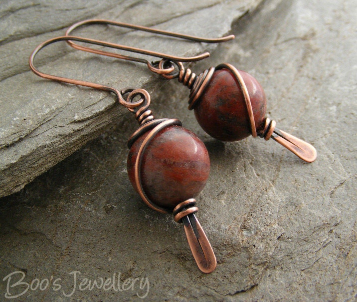 Antiqued copper earrings with red flower marble beads spiral wrapped on a hammered paddle headpin