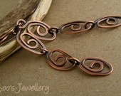 Antiqued copper earrings featuring long drops of hand crafted spiral eye links