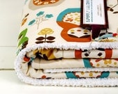 baby blanket, matryoshka or nesting dolls in autumnal tones, parent-friendly.