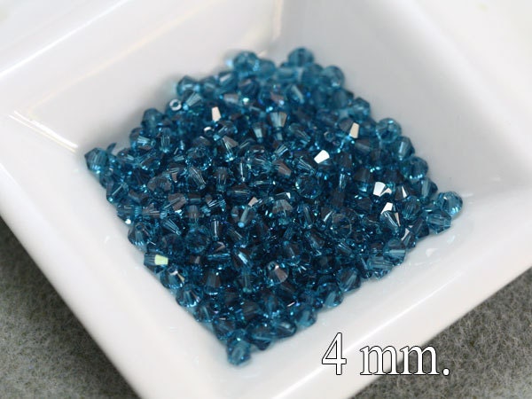 100 pcs. Swarovski Crystal Bicone Indicolite 4 mm.