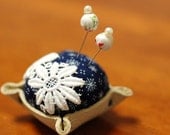 Leather bottom pincushion with two cute pins