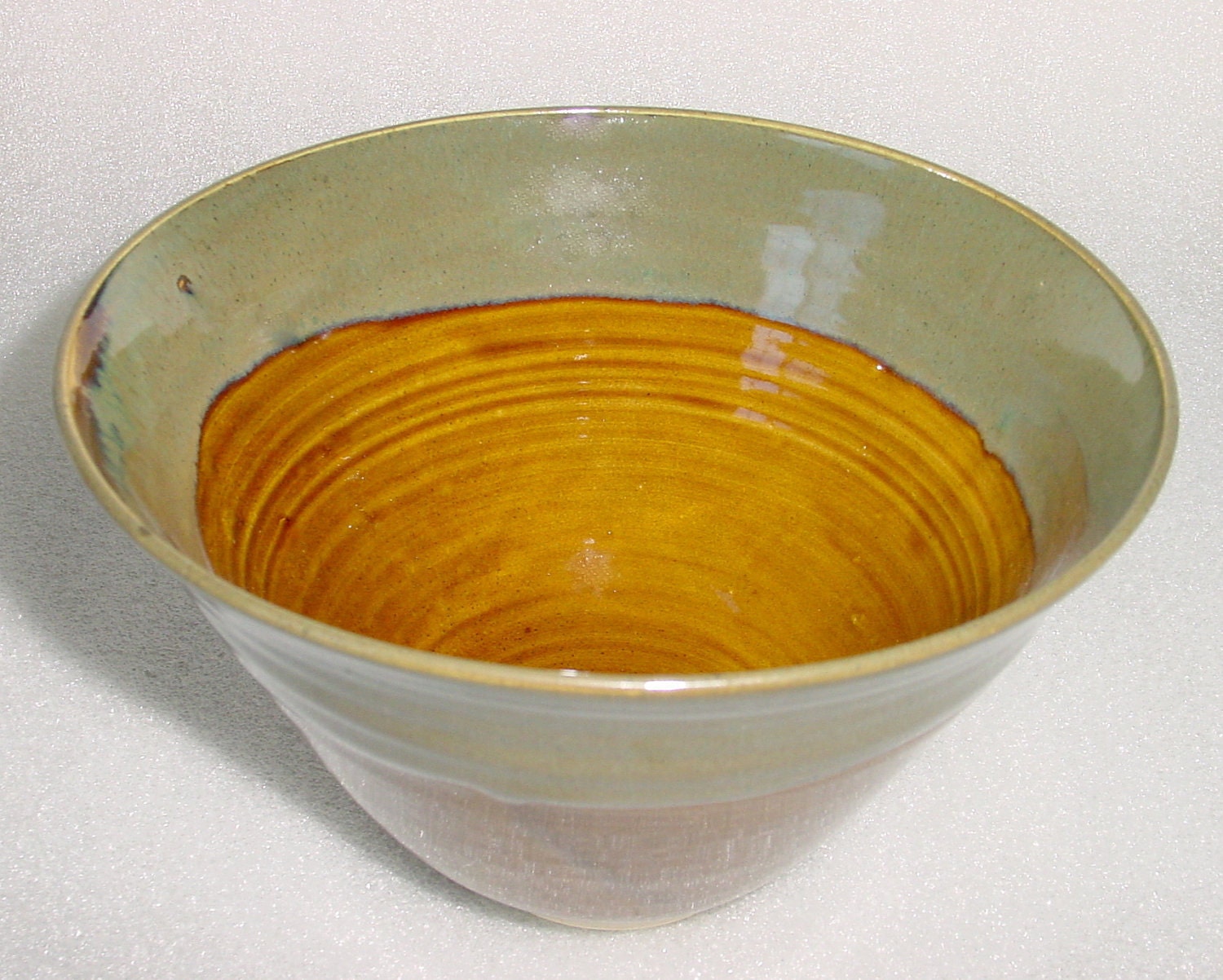 Pottery Bowl in Amber with Sage Green and Blue around the Rim