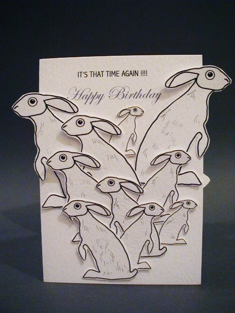 Its That Time Again  Happy Birthday Handmade Card in White with lots and lots of Grey Hares  - can fit a max of 65 hares on - thats old eh