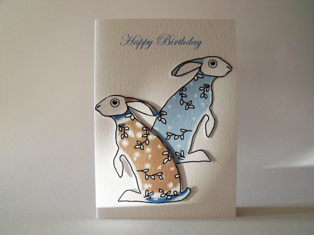 Happy Birthday in blue Handmade Card   with blue and brown hares in Norwegian jumper and winter Sprig pattern