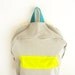 Light grey with thin stripes backpack with neon yellow pouch
