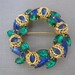 Vintage Circle Pin of Faux Emeralds and Sapphires with Goldtone Filigree Wrap