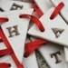 Porcelain Happy Christmas Garland, real gold lustre, red ribbon