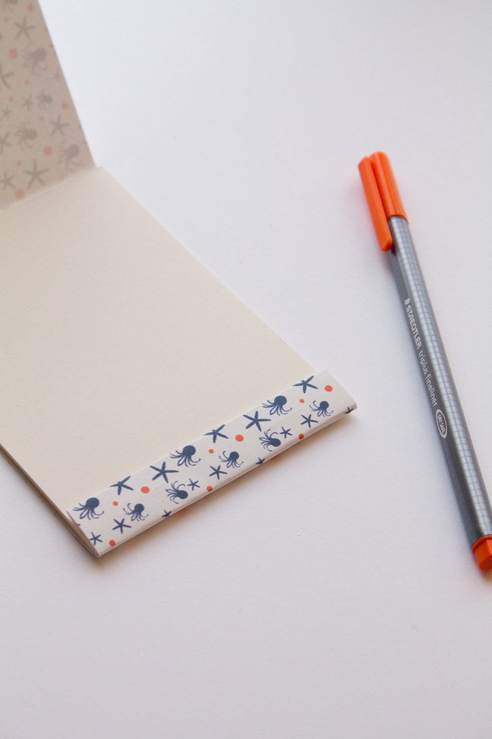 Notepad, orange and navy blue pattern with octopus and sea stars