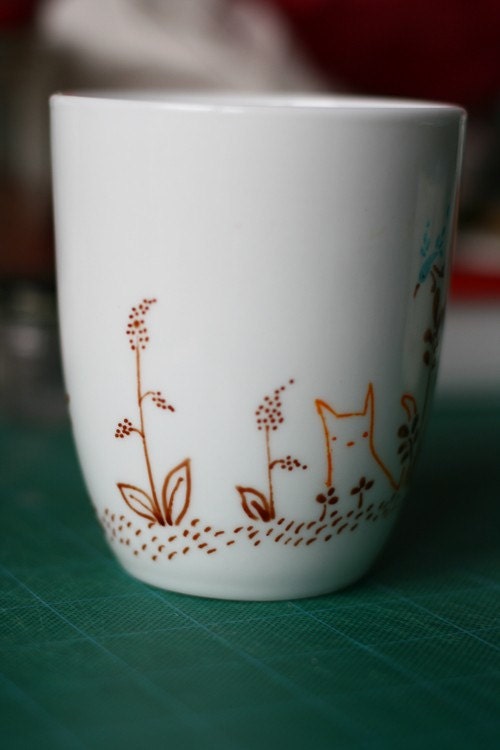 Orange cat and blue bird mug