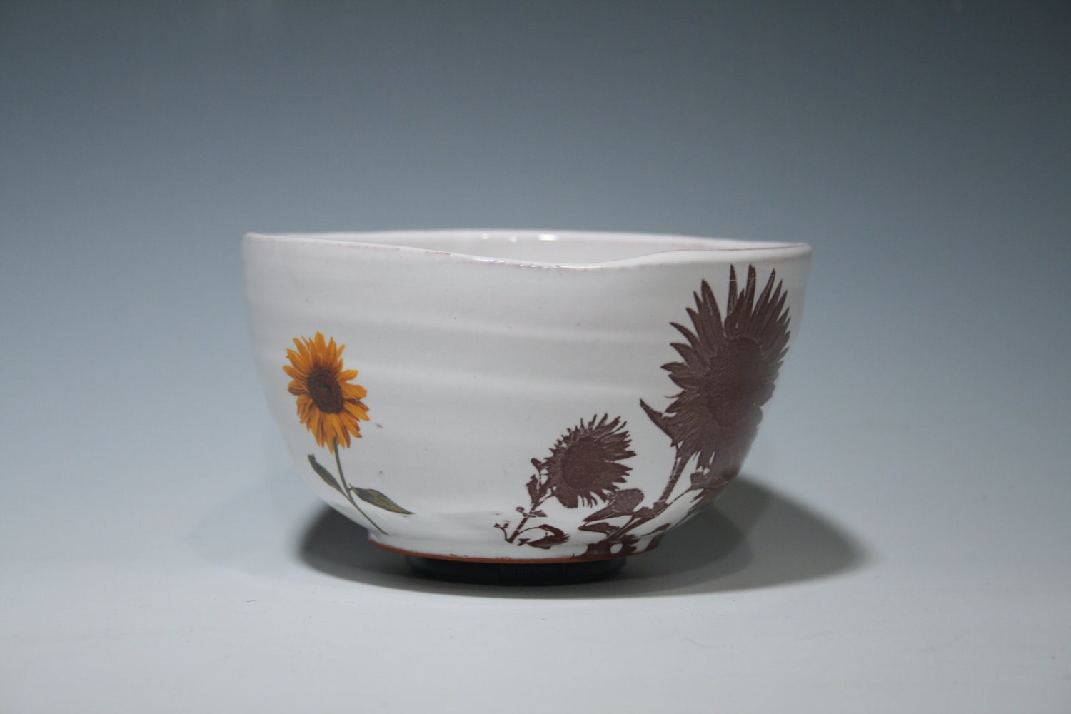 Handmade bowl with images of sunflowers and glossy white glaze