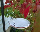 Enamel lid with new life as a bird feeder