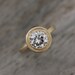 Moissanite and 14k Yellow Gold Engagement Ring, Matte Gold and MIlgrain Textured Bezel