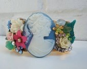 Vintage brass cuff bracelet with beautiful powder blue cameo, enamel and carved roses, flowers, crystals, rhinestones and  leaves .