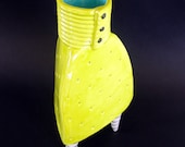 chartreuse ceramic vase with 3 black & white striped legs