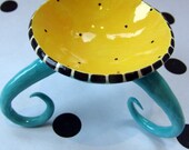 colorful turquoise dish with curly legs