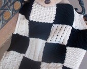 Small,  knitted, patchwork blanket in black and cream
