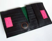 Recycled bike inner tube bifold wallet with neon pink velcro closure and dark green linen