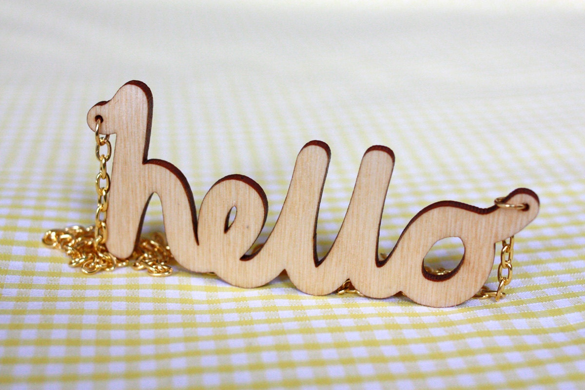 Hello Wooden Necklace. Laser cut in eco friendly birch wood. Gold or silver plated chain.