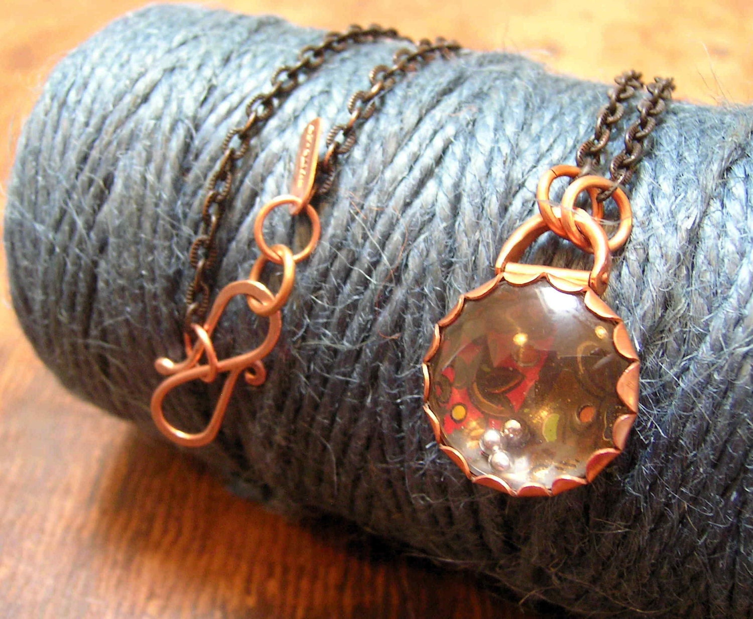 Puzzle Pod necklace pendant game, in copper.