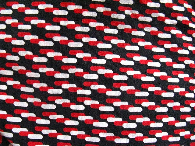 vintage fabric - synthetic -  red and white capsules on black - one metre